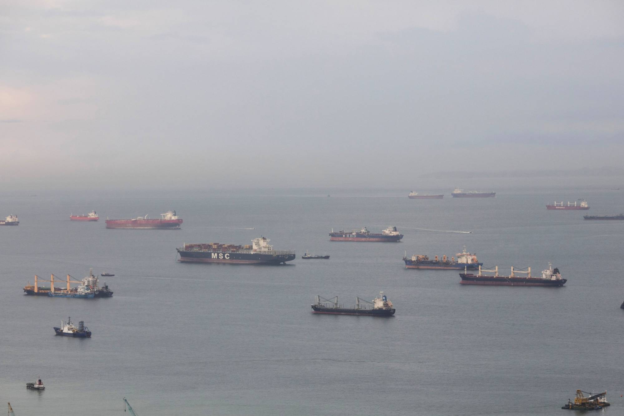Ships sit offshore in the Singapore Strait in 2018. | BLOOMBERG