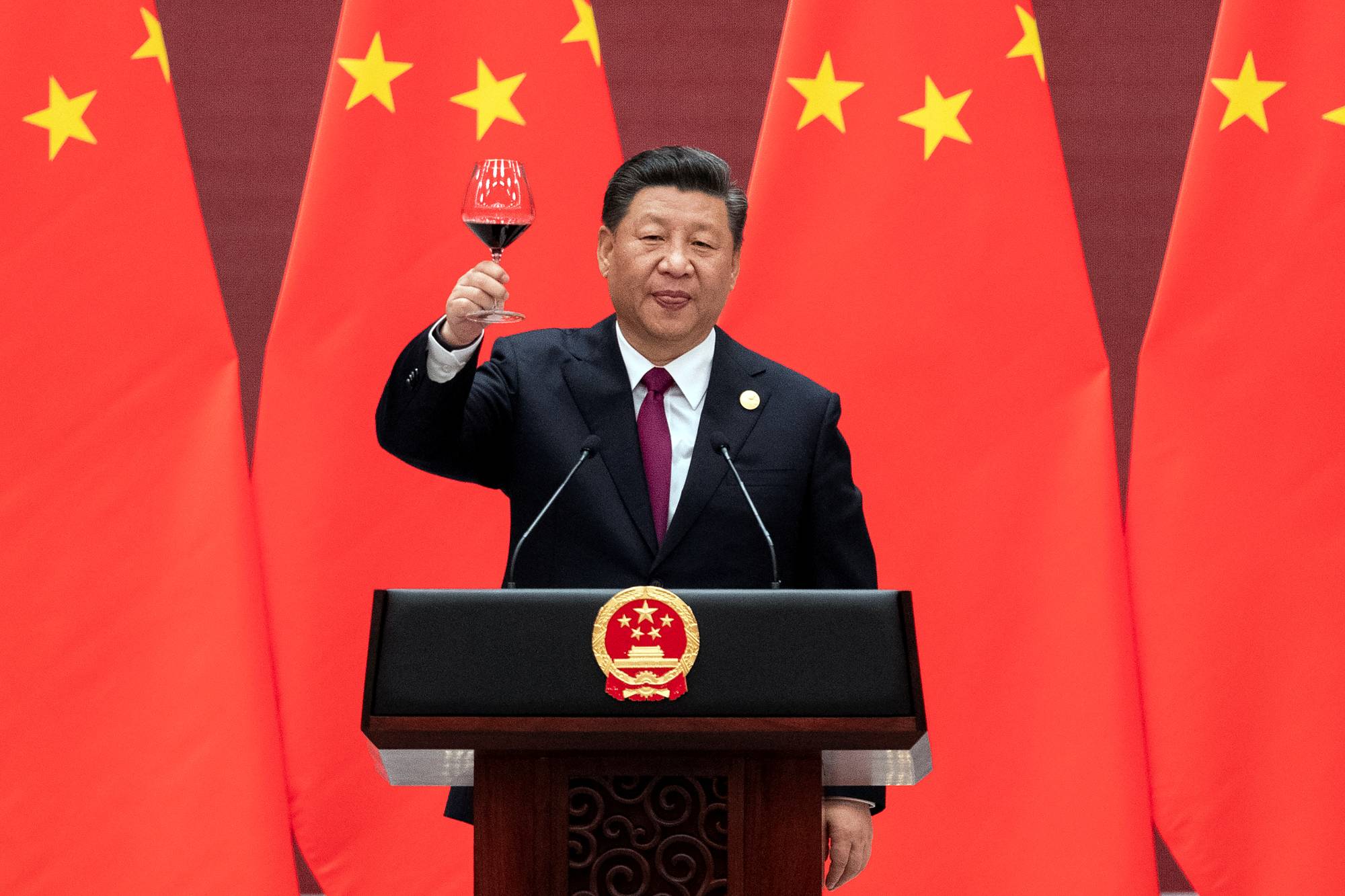 Chinese President Xi Jinping raises his glass and proposes a toast at the end of his speech during a banquet after the welcome ceremony of leaders attending the Belt and Road forum at the Great Hall of the People in Beijing in April 2019. | POOL VIA / REUTERS