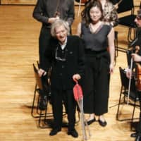 Seiji Ozawa (center) acknowledges the audience after conducting at a music festival in Matsumoto, Nagano Prefecture, in August 2019. | KYODO
