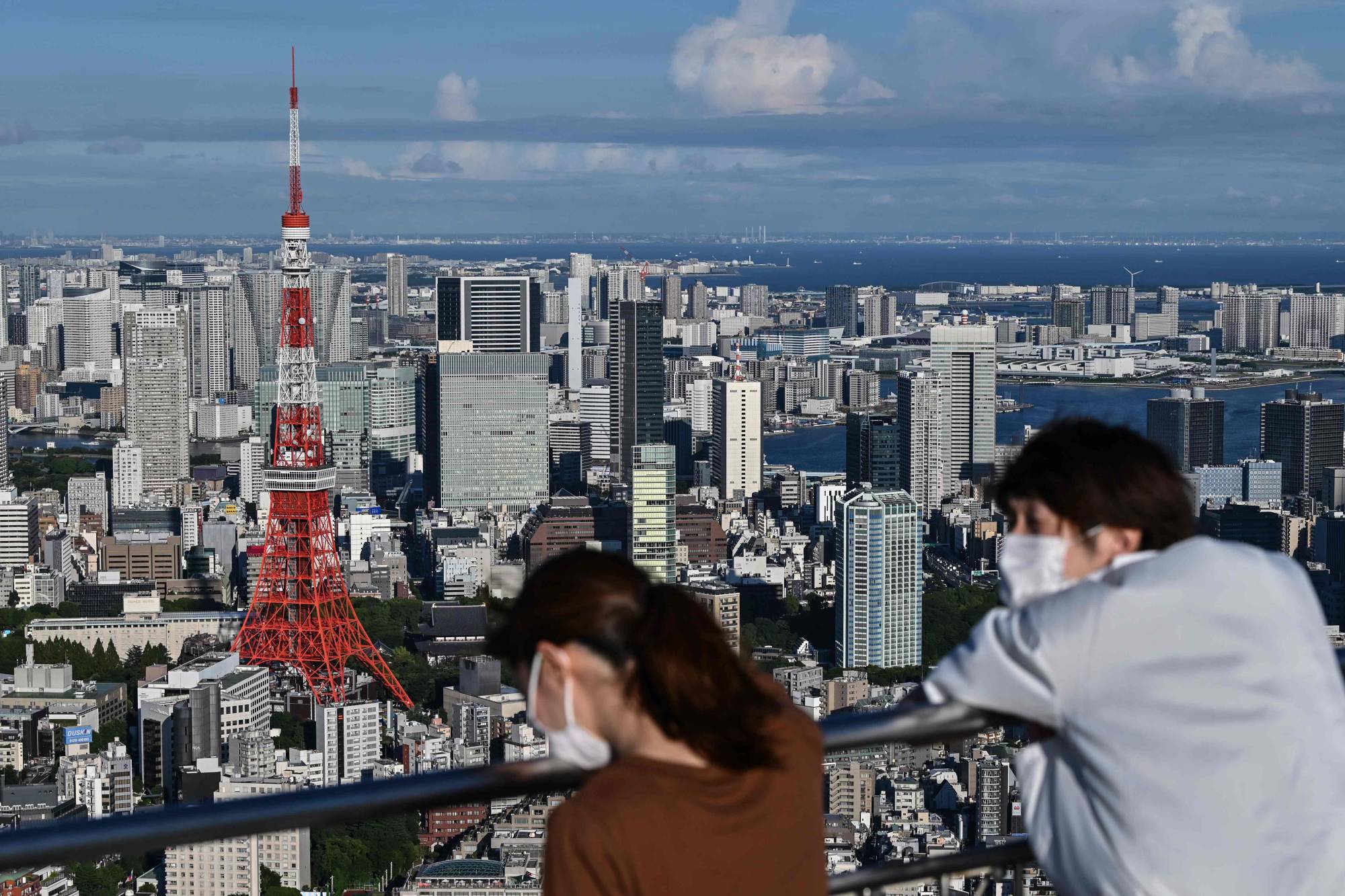 People view Tokyo Tower from an observation deck in the capital. | AFP-JIJI