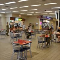 Tables in the food court area have been spaced out, with visitors required to keep masks on except when they are eating. | TOMOHIRO OSAKI