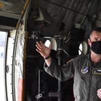 Lt. Col. Steve Massie explains Monday that his aircrew are required to observe strict social distancing and mask-wearing policies regardless of temperature or weather. | TOMOHIRO OSAKI

