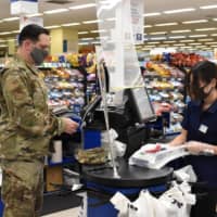 Plastic shields and diagrams reminding visitors to observe a six-foot distance have become ubiquitous at Yokota Air Base in the city of Fussa in Tokyo. | TOMOHIRO OSAKI