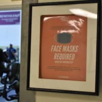 Some treadmills have been marked as unavailable at the Samurai Fitness Center, where hand sanitizers and reminders of mask-wearing policies are omnipresent. | TOMOHIRO OSAKI
