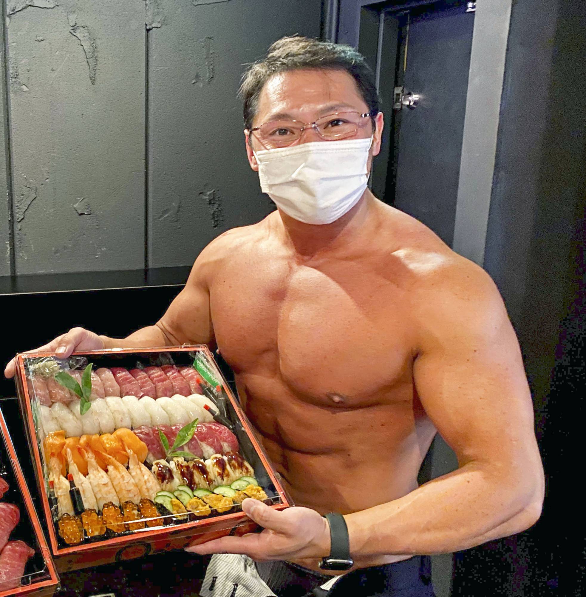 Masanori Sugiura, owner of sushi restaurant Imazushi in Anjo, Aichi Prefecture, is among several top-ranking bodybuilders acting as couriers for the eatery. | COURTESY OF MASANORI SUGIURA / VIA KYODO