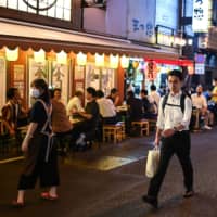 People gather at an eatery in Tokyo on Friday.  | AFP-JIJI