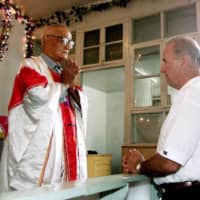 Joe Biden, then a U.S. senator, meets Catholic priest Zhang Depu in his church in Yanzikou Village, north of Beijing, in 2001.  | REUTERS