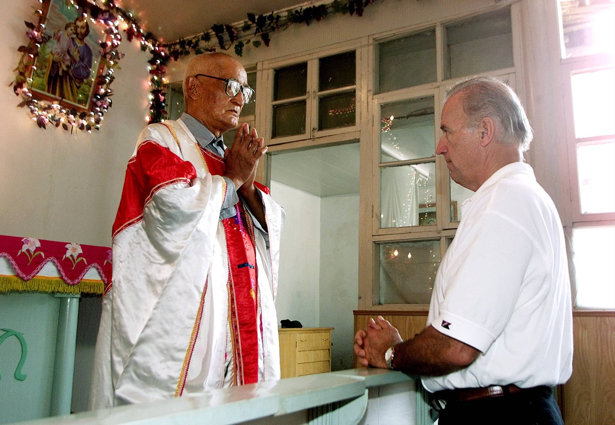 Joe Biden, then a U.S. senator, meets Catholic priest Zhang Depu in his church in Yanzikou Village, north of Beijing, in 2001. | REUTERS