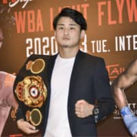 Hiroto Kyoguchi poses with the WBA light flyweight super championship belt at a news conference in Osaka on Tuesday. | KYODO