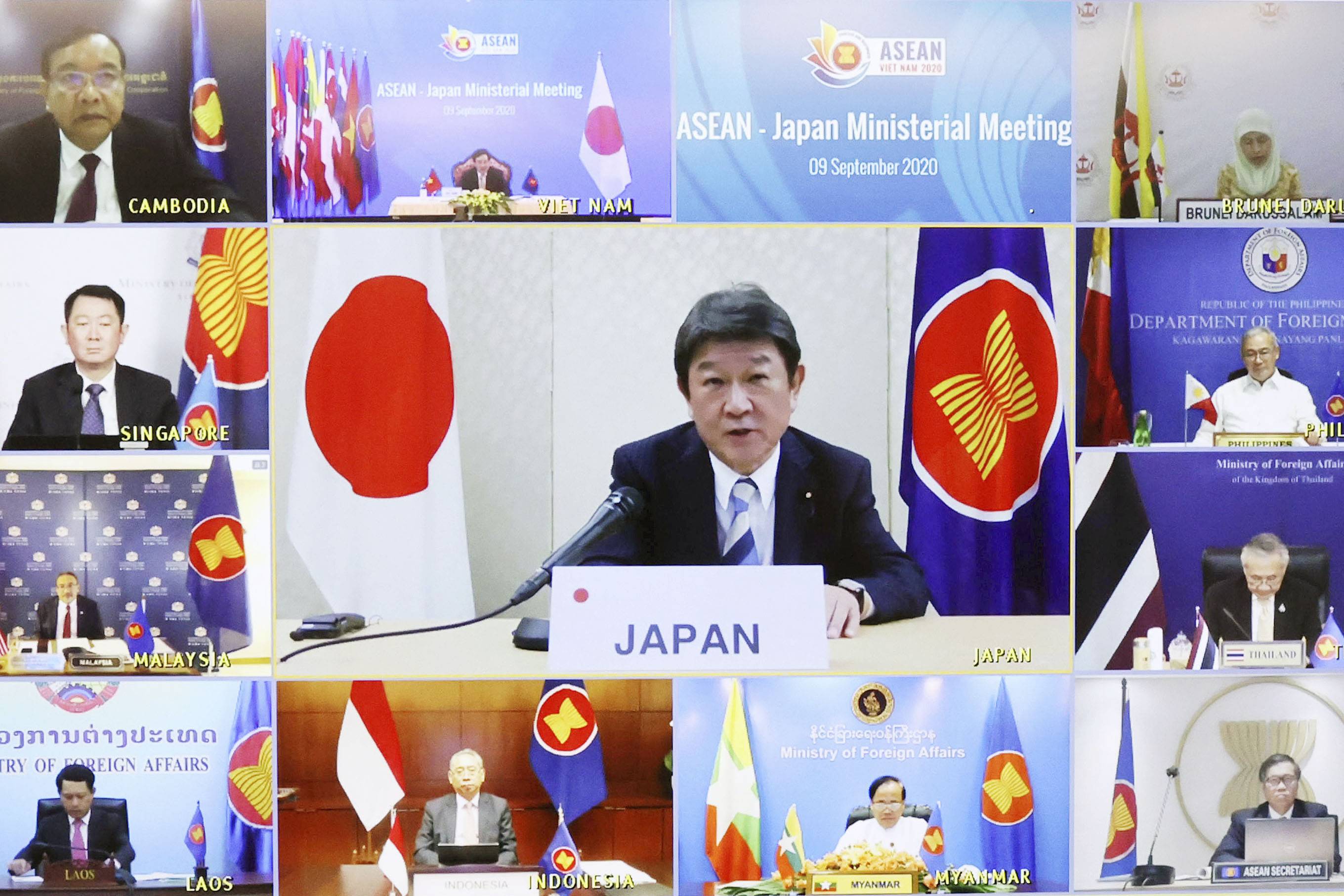 Foreign Minister Toshimitsu Motegi (center) and his counterparts from ASEAN, China and South Korea attend a videoconference Wednesday. | POOL / VIA KYODO