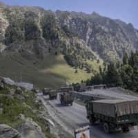 An Indian army convoy moves on the Srinagar-Ladakh highway at Gagangeer, northeast of Srinagar, Indian-controlled Kashmir, on Sept. 9. | AP