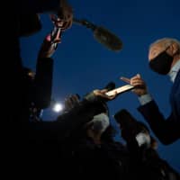 Democratic U.S. presidential candidate Joe Biden speaks with the media as he departs Detroit Metro Wayne County Airport in Romulus, Michigan, on Wednesday. | AFP-JIJI