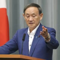 Chief Cabinet Secretary Yoshihide Suga speaks at a news conference at the Prime Minister\'s Office on Friday. | KYODO