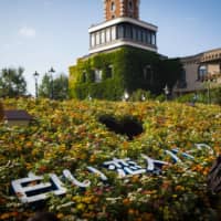 Visitors walk past a display at Shiroi Koibito Park in Sapporo in August. | BLOOMBERG