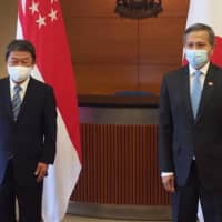 Foreign Minister Toshimitsu Motegi (left) and his Singaporean counterpart Vivian Balakrishnan pose for a photo in Singapore on Aug. 13. | FOREIGN MINISTRY / VIA KYODO
