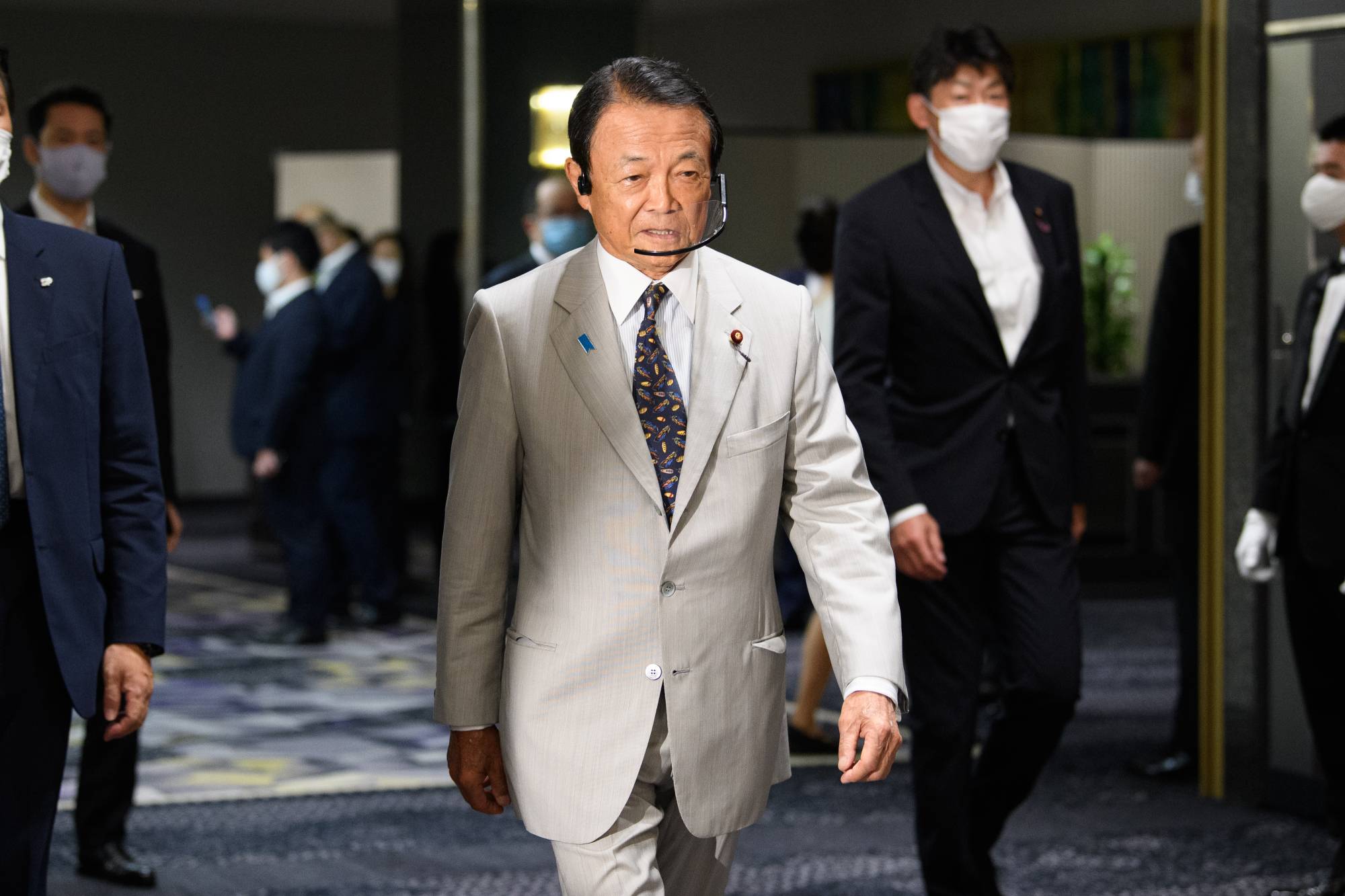 Deputy Prime Minister Taro Aso arrives for a ceremony marking the beginning of Chief Cabinet Secretary Yoshihide Suga's campaign for the Liberal Democratic Party leadership race in Tokyo on Tuesday. | BLOOMBERG