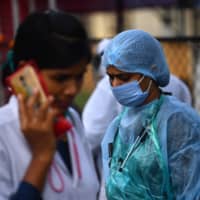 Doctors work at a COVID-19 quarantine center in Nashik, India, on Sunday.  | AFP-JIJI