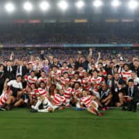 The Brave Blossoms pose for photos after their win over Scotland at the Rugby World Cup on Oct. 13, 2019. | REUTERS
