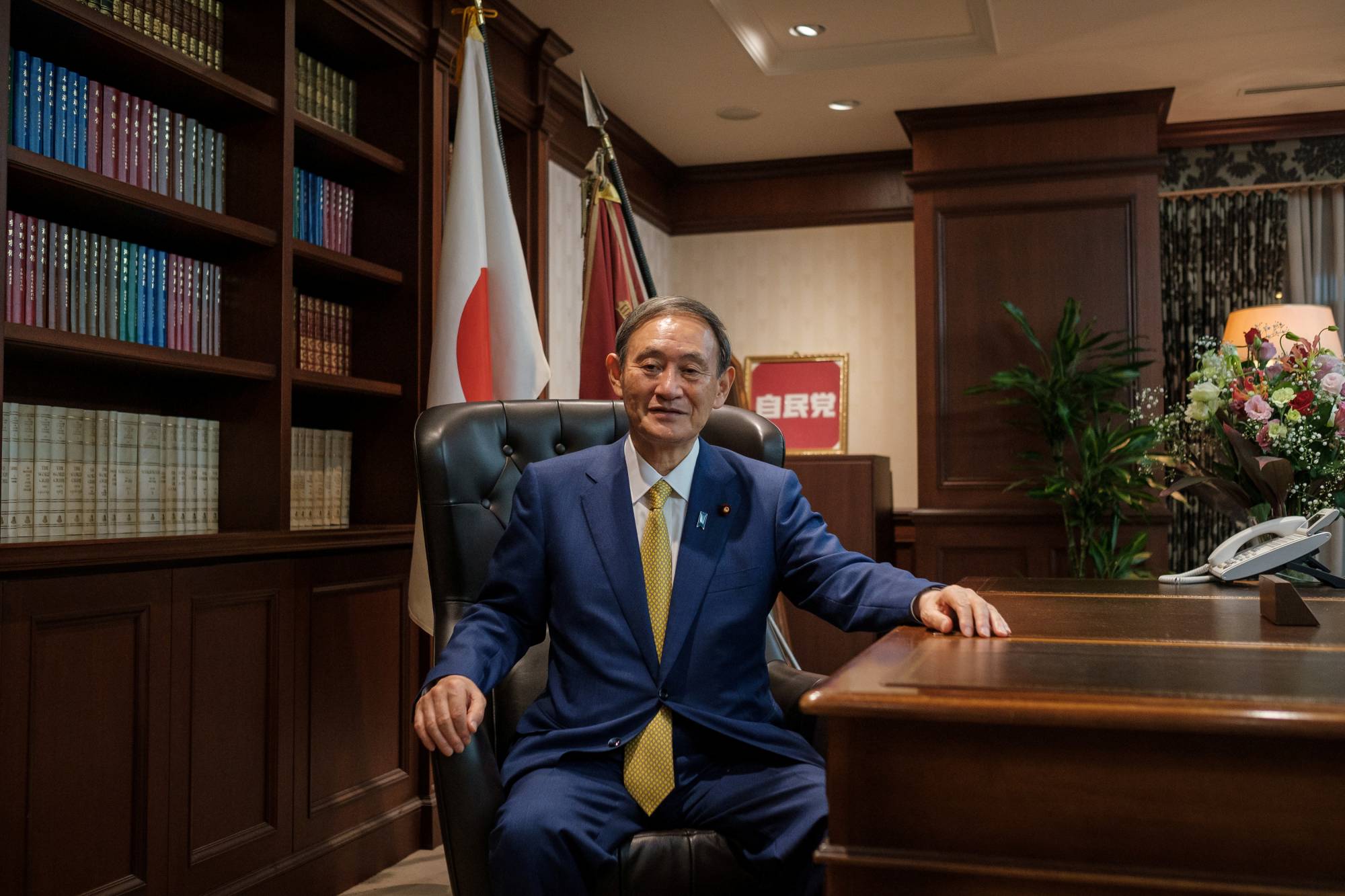 Newly elected Liberal Democratic Party chief Yoshihide Suga poses for a picture following a news conference at LDP headquarters in Tokyo on Monday. | POOL / VIA REUTERS