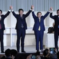 LDP Policy Research Council Chairman Fumio Kishida (from left to right), Prime Minister Shinzo Abe, chief Cabinet secretary Yoshihide Suga and LDP lawmaker Shigeru Ishiba acknowledge the crowd during the party\'s leadership election in Tokyo on Monday.  | AP
