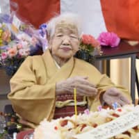 Kane Tanaka, recognized as the world\'s oldest living person by Guinness World Records, receives a birthday cake for her 117th birthday at a nursing home in the city of Fukuoka in January. Japan\'s centenarians surpassed 80,000 for the first time this year, government data shows. | KYODO
