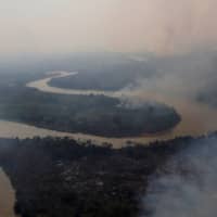 Smoke rises into the air around the Cuiaba River in the Pantanal.  | REUTERS 