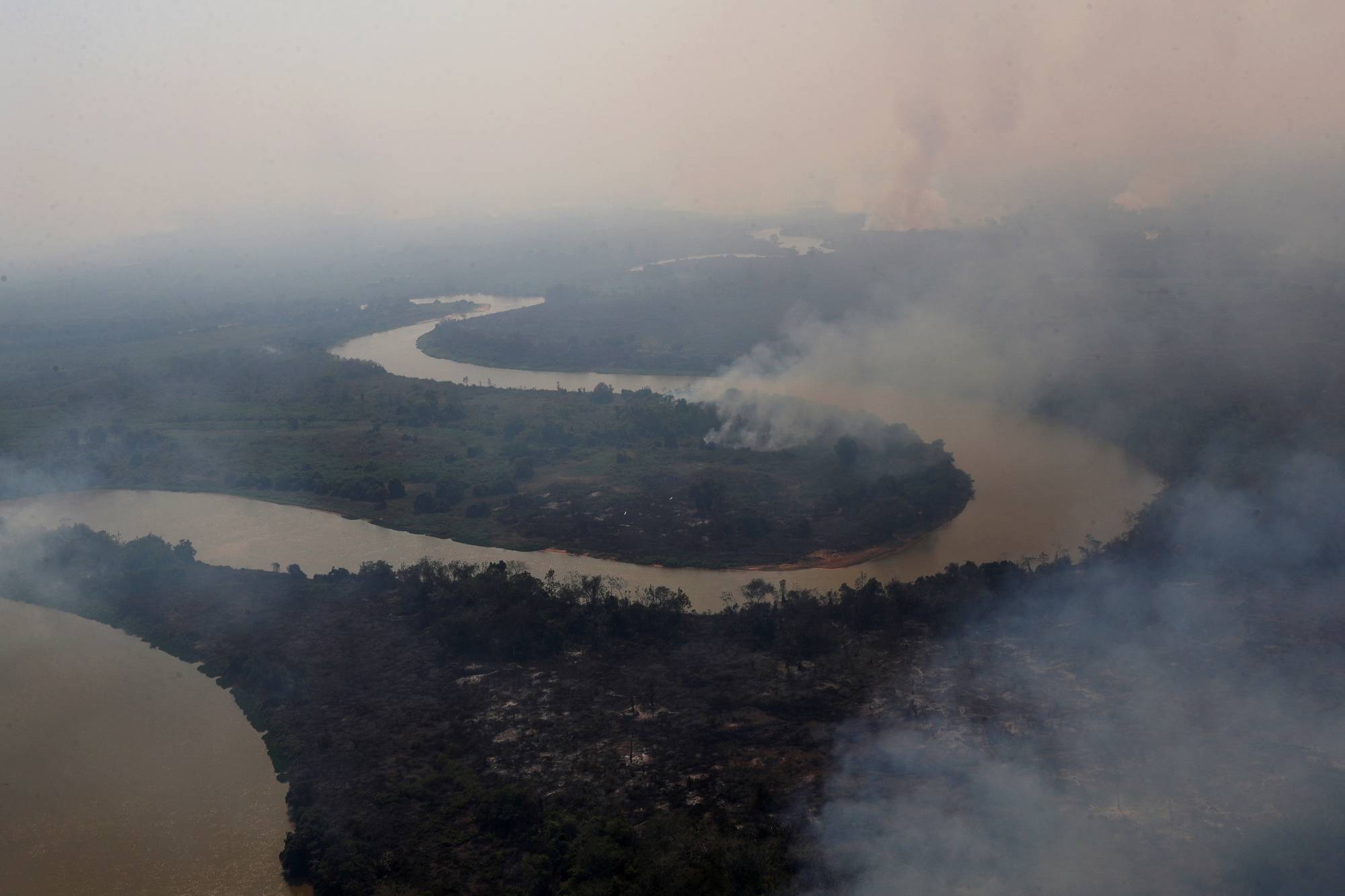 Smoke rises into the air around the Cuiaba River in the Pantanal.  | REUTERS 