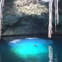 Into the blue: For Mayan communities living near cenotes, the natural sinkholes are an essential source of freshwater as well as a mystical link between life and death. | © KAORI ODA
