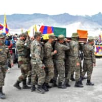 Indian soldiers carry a coffin containing the body of Tenzin Nyima on Sept. 7.  | REUTERS 