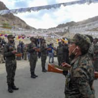 Indian soldiers pay their respects during the funeral of their comrade, Tenzin Nyima, a senior-rank Tibetan official from India\'s Special Frontier Force, on Sept. 7.
 | AFP-JIJI