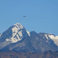 An Indian fighter jet flies over a mountain range in Leh, the joint capital of the union territory of Ladakh bordering China, on Sept. 2. | AFP-JIJI