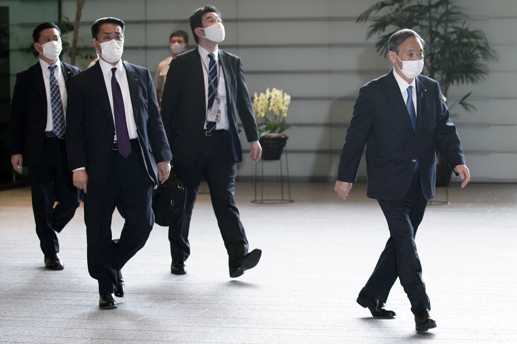 Yoshihide Suga, the nation's new prime minister, leaves the Prime Minister's Office on Wednesday. | AP