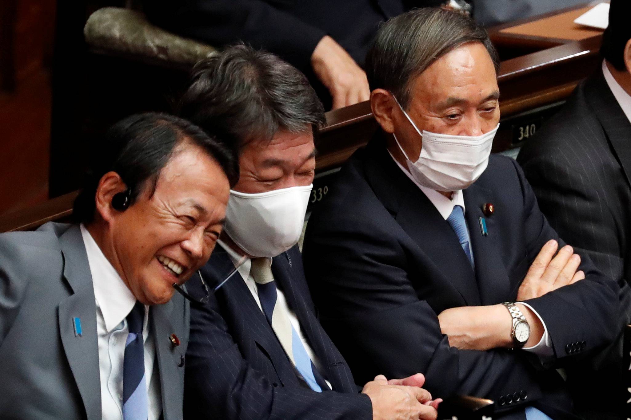 Remarks by Cabinet ministers, including Finance Minister Taro Aso (left), have added fuel to speculation about an early election. | REUTERS