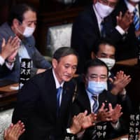 Yoshihide Suga reacts after he was elected prime minister by the Lower House on Wednesday. | AFP-JIJI