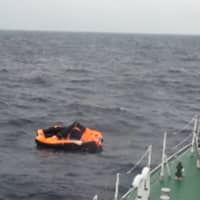 A man is rescued from a life raft by the Japan Coast Guard on Sept. 4 after a cargo ship capsized due to a typhoon.
 | JAPAN COAST GUARD / VIA AFP-JIJI