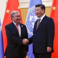 United Nations Secretary-General Antonio Guterres greets Chinese President Xi Jinping before a meeting at the Great Hall of the People in Beijing in 2018. | REUTERS 