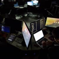 Students use computers during a cyberdefense programming class in the \"War Room\" at Korea University in Seoul in November 2015. | BLOOMBERG