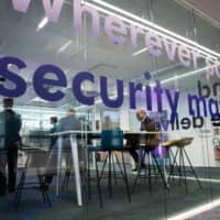 A security sign is printed on a glass surface in an office space during the Thales SA cybersecurity event in Paris in April 2018. | BLOOMBERG