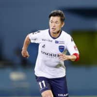 Yokohama FC\'s Kazuyoshi Miura dribbles toward the Frontale goal during the first half on Wednesday in Kawasaki. | KYODO
