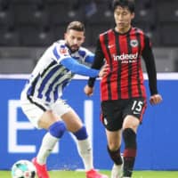 Daichi Kamada (right) competes for Eintracht during a match against Hertha on Friday in Berlin. | KYODO