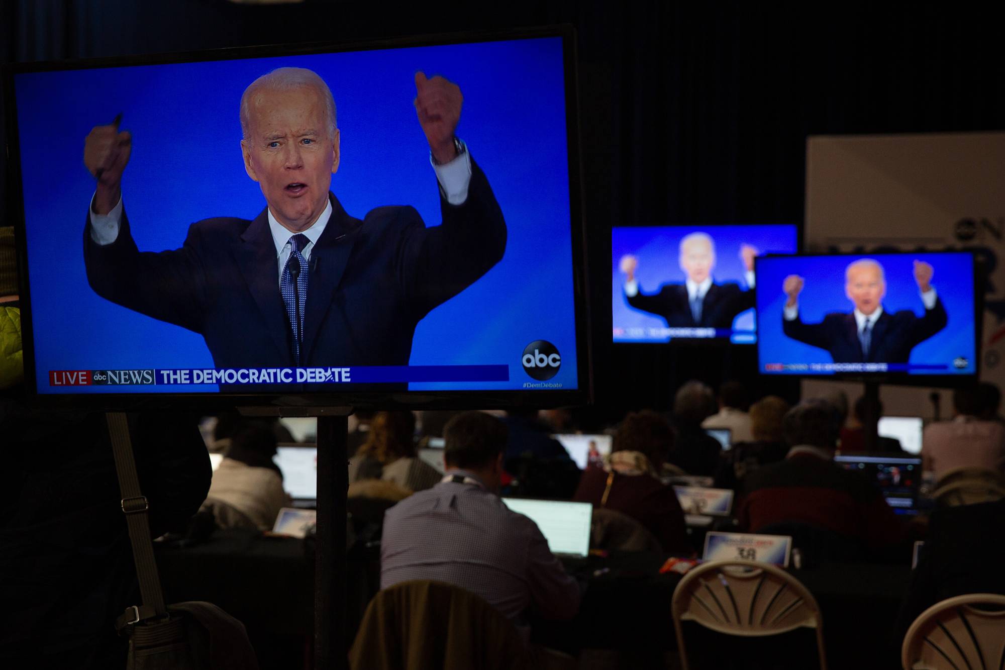 People watch former Vice President Joe Biden during the Democratic presidential debate at Saint Anselm College in Manchester, New Hampshire, on Feb. 7. | Elizabeth Frantz / The New York Times