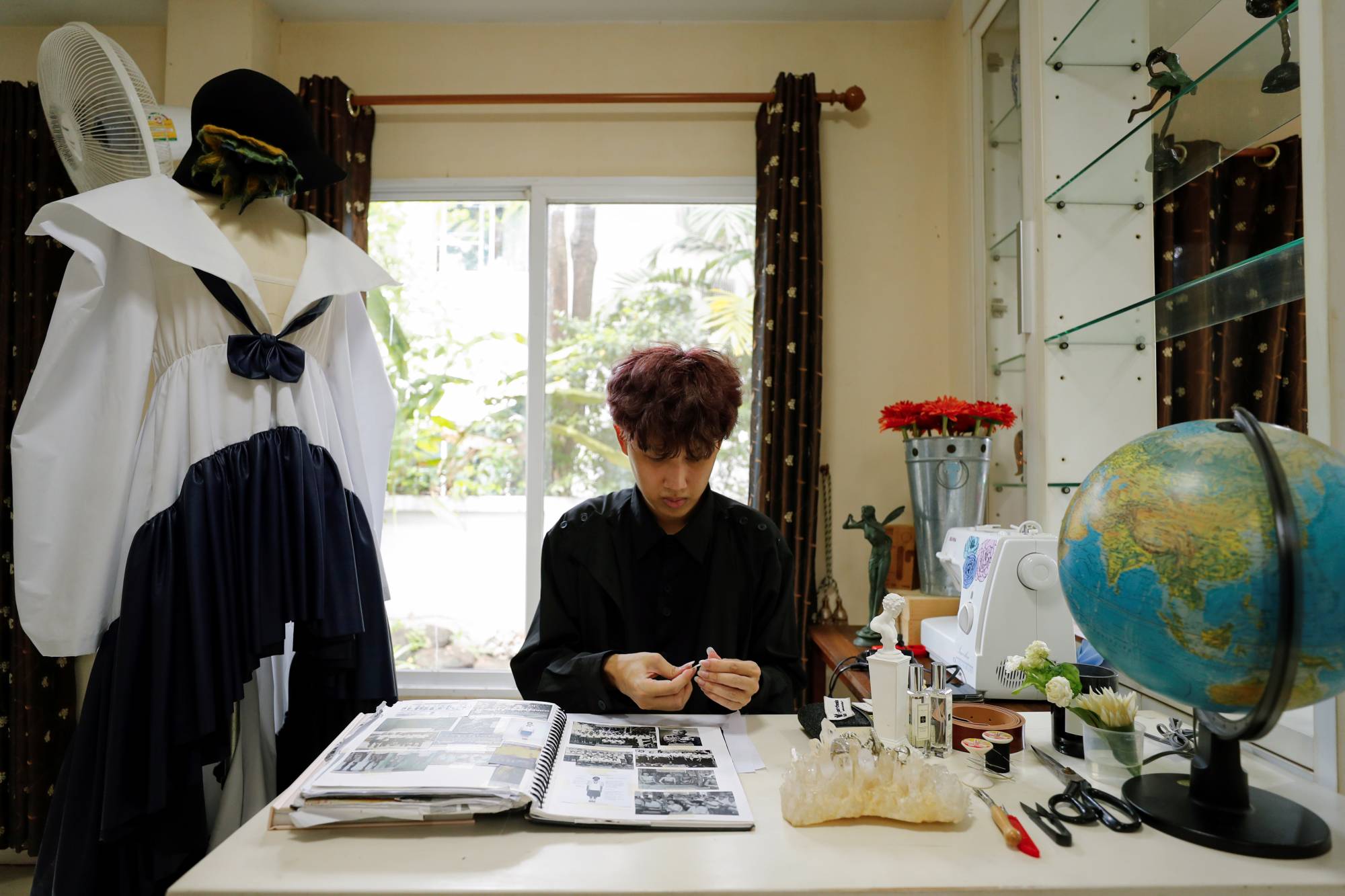 Thai designer Tin Tunsopon works in his studio in Bangkok. | REUTERS 