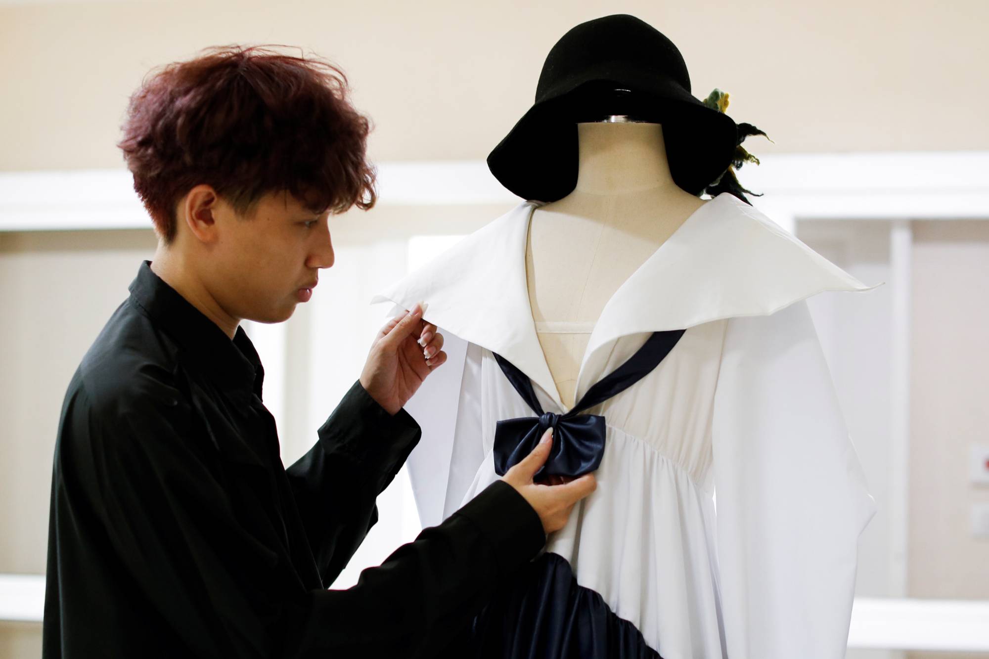 Tin Tunsopon shows one of his creations in his studio. | REUTERS 