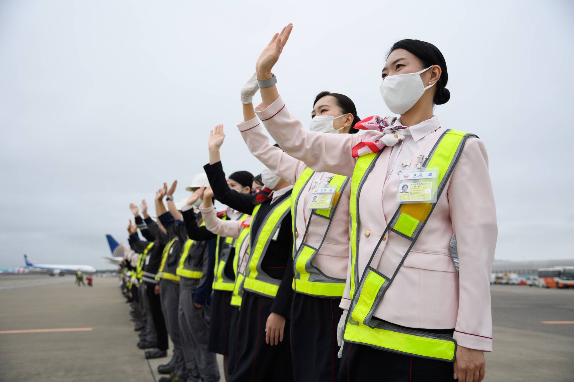 Japan Airlines Co. employees wave to see off a Boeing 767-300ER aircraft at Narita Airport in Chiba Prefecture. | BLOOMBERG
