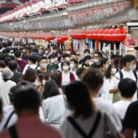 People visit the Nakamise shopping street in Tokyo\'s Asakusa district during the four-day holiday that started Sept. 19.