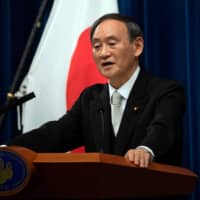 Prime Minister Yoshihide Suga will not visit South Korea without a guarantee on wartime labor row, Foreign Ministry official says. | POOL / VIA REUTERS