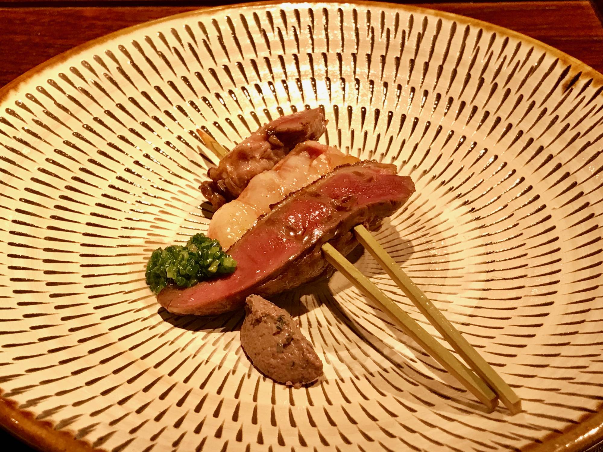 Two-pronged dish: Slices of still-rare pigeon meat are sandwiched around a single, plump amaebi (spot prawn), all held together with skewers. | ROBBIE SWINNERTON