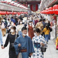 People walk on the Nakamise shopping street in Tokyo\'s Asakusa district Thursday. | KYODO
