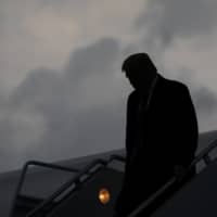 U.S. President Donald Trump descends from Air Force One at Joint Base Andrews in Maryland on Thursday evening after a fundraiser in New Jersey. Trump revealed early Friday morning that he and the first lady, Melania Trump, had tested positive for the coronavirus, throwing the nation’s leadership into uncertainty and escalating the crisis posed by a pandemic that has already killed more than 200,000 Americans and devastated the economy. | ERIN SCHAFF / THE NEW YORK TIMES