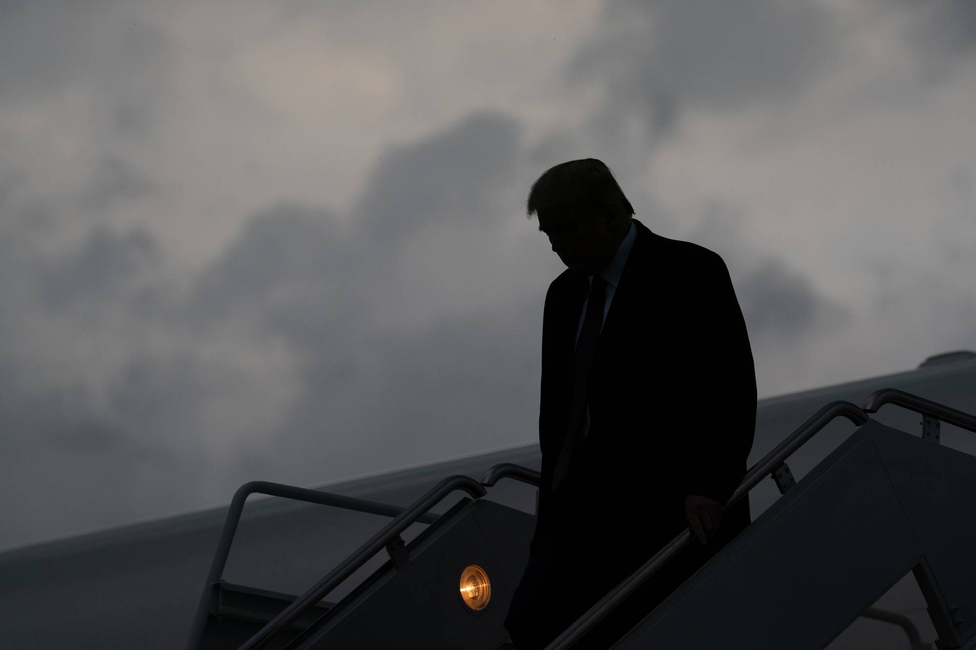 U.S. President Donald Trump descends from Air Force One at Joint Base Andrews in Maryland on Thursday evening after a fundraiser in New Jersey. Trump revealed early Friday morning that he and the first lady, Melania Trump, had tested positive for the coronavirus, throwing the nation’s leadership into uncertainty and escalating the crisis posed by a pandemic that has already killed more than 200,000 Americans and devastated the economy. | Erin Schaff / The New York Times